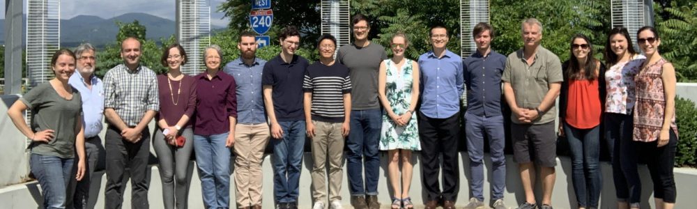 A photo of the research group standing outside the location of their 2019 workshop.